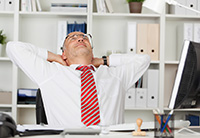 Man stretching at desk
